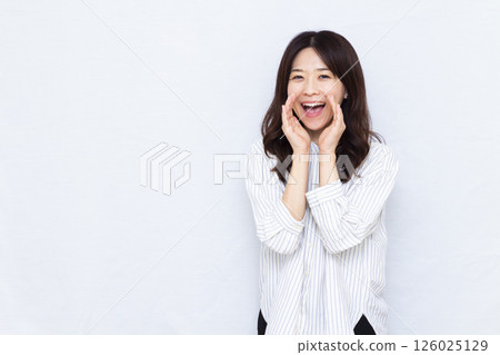 A woman calling out with a smile 126025129