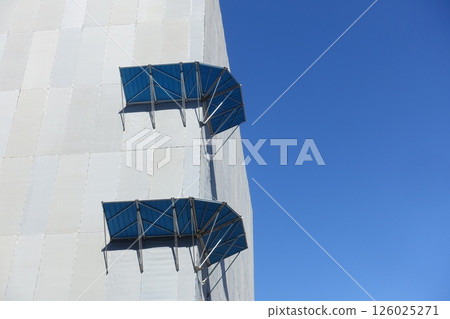 Morning glory on scaffolding for repair work on the exterior wall of a high-rise building 126025271