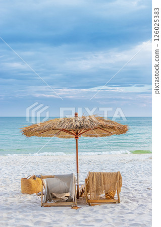 beautiful tranquil white sand beach with two beach chair and thatched umbrella with copy space. romantic summer vacation at tropical private island for luxury sea resort advertising background. beautiful tranquil white sand beach with two beach chair and thatched umbrella with copy space. romantic summer vacation at tropical private island for luxury sea resort advertising background. 126025383