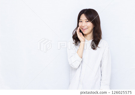 Smiling woman whispering 126025575
