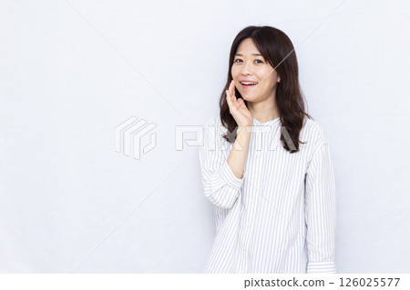 Smiling woman whispering Smiling woman whispering 126025577