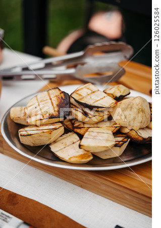 Grilled apple slices with char marks on serving plate. 126025584