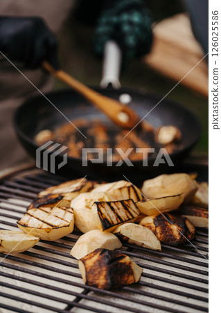 Grilling apples on outdoor BBQ for homemade dessert Grilling apples on outdoor BBQ for homemade dessert 126025586