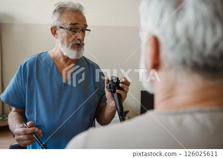 Doctor explaining gastroscopy procedure on patient. Examination of upper digestive tract. Doctor explaining gastroscopy procedure on patient. Examination of upper digestive tract. 126025611