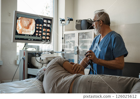 Gastroscopy procedure on sedated patient to examine upper digestive tract. Gastroscopy procedure on sedated patient to examine upper digestive tract. 126025612