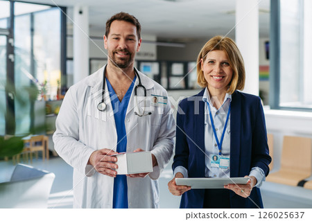 Pharmaceutical rep meeting with healthcare professional to discuss new drugs 126025637