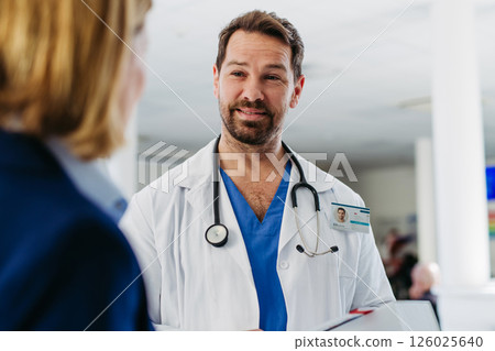 Female medical sales representative presenting medication to doctor Female medical sales representative presenting medication to doctor 126025640