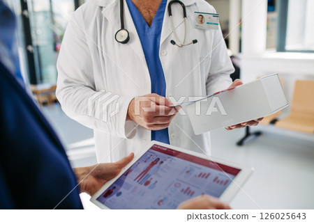 Business interaction between pharma rep and healthcare provider. Business interaction between pharma rep and healthcare provider. 126025643