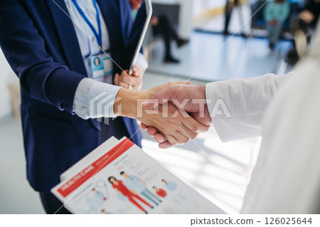 Business interaction, handshake between pharma rep and healthcare provider. Business interaction, handshake between pharma rep and healthcare provider. 126025644