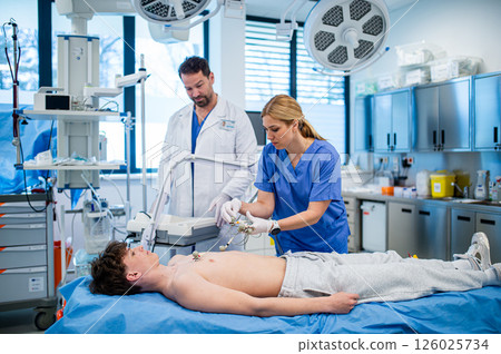 Preoperative EKG examination of teenage patient in hospital setting. Preoperative EKG examination of teenage patient in hospital setting. 126025734