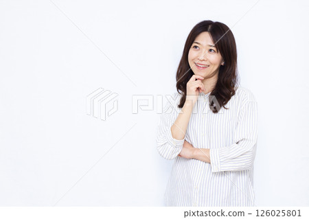 Woman thinking with a smile 126025801