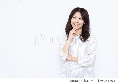Woman thinking with a smile Woman thinking with a smile 126025803
