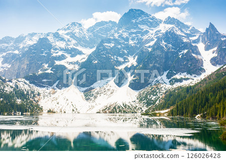 landscape with lake in tatra mountains of poland in spring. beautiful travel destination of europe. outdoor adventure and vacation season on morskie oko landscape with lake in tatra mountains of poland in spring. beautiful travel destination of europe. outdoor adventure and vacation season on morskie oko 126026428