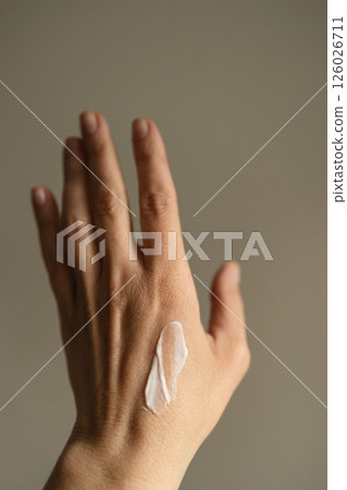 Female hand with moisturizing cream. Female hand with moisturizing cream. 126026711