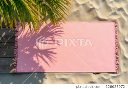 Pink yoga mat lying on sand in shade of palm trees, top view, space for text 126027072