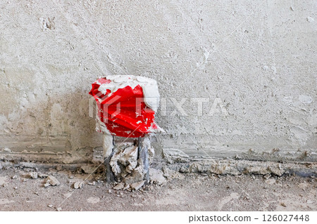 A can of soda is currently sitting on the ground next to a wall nearby A can of soda is currently sitting on the ground next to a wall nearby 126027448