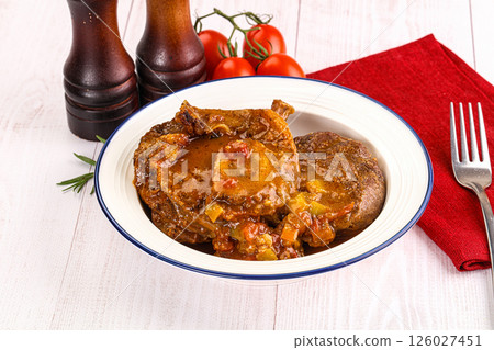 Italian cuisine - ossobuco with sauce Italian cuisine - ossobuco with sauce 126027451