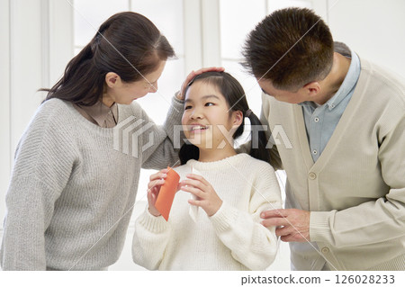 Grandmother and grandfather giving New Year's money to their grandchild 126028233
