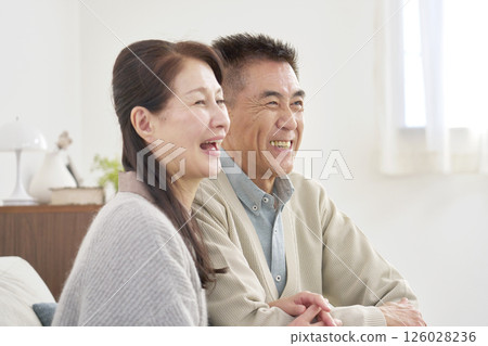 Senior couple portrait living room Senior couple portrait living room 126028236