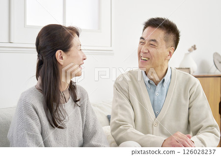 Senior couple having a conversation in the living room Senior couple having a conversation in the living room 126028237