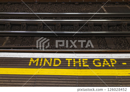 Mind the Gap Warning Sign on London Underground Platform Edge for Passenger Safety 126028452