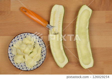 Halves of a zucchini being scooped Halves of a zucchini being scooped 126029254