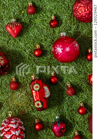 Red Christmas tree glass ball toys on green 126029467