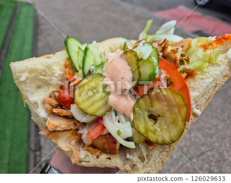 Tasty kebab in man hand. Tasty kebab in man hand. 126029633