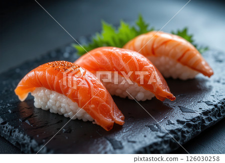 Japanese Sushi Nigiri with Salmon on a Dark Stone Surface 126030258