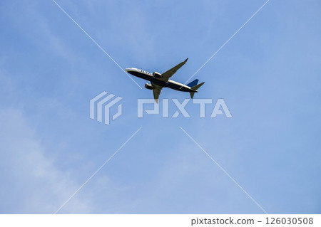 Airplane Flying Through Clear Blue Sky 126030508