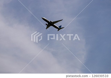 Airplane Flying Through Clear Blue Sky Airplane Flying Through Clear Blue Sky 126030510