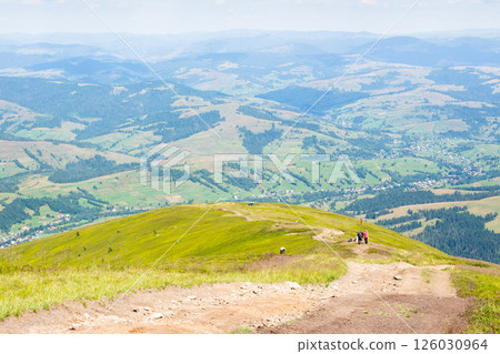 scenery with hiking path in summer. distant horizon. beautiful mountain landscape with green hills and steep slopes. trail through borzhava ridge. view in to the valley. spectacular highland of 126030964