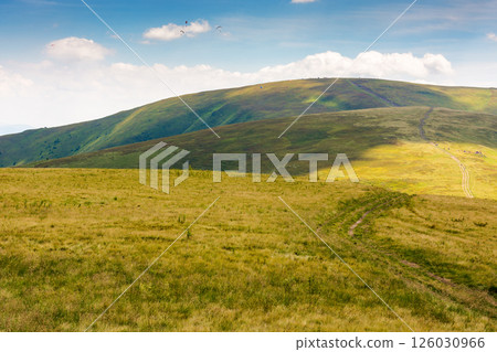 green mountain landscape with trail for hiking. vacation season. path through nature hill to the top for outdoor travel and beautiful view. alpine tourism scenery in summer with sky and cloud green mountain landscape with trail for hiking. vacation season. path through nature hill to the top for outdoor travel and beautiful view. alpine tourism scenery in summer with sky and cloud 126030966