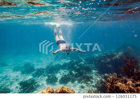 Snorkeling and skin diving on the coral reef edge in tropical waters... 126031175