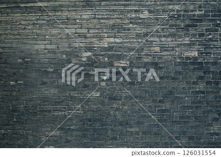 Dark gray brick wall forming a textured background Dark gray brick wall forming a textured background 126031554