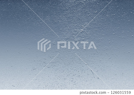 Metallic background with light blue gradient and rough texture creating an abstract pattern 126031559