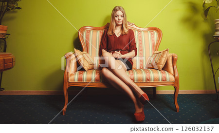 Pretty young woman on vintage sofa. Fashion. Pretty young woman on vintage sofa. Fashion. 126032137