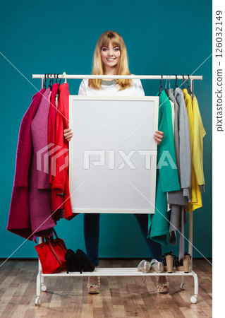 Woman in mall wardrobe with blank banner copyspace Woman in mall wardrobe with blank banner copyspace 126032149