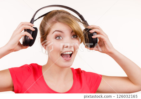 Woman in big headphones listening music isolated 126032165