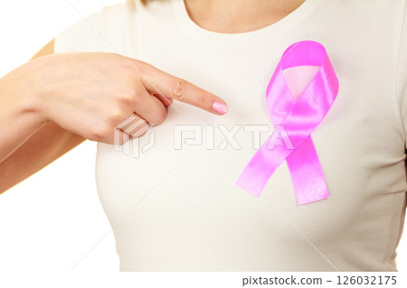 Closeup pink cancer ribbon on woman chest Closeup pink cancer ribbon on woman chest 126032175