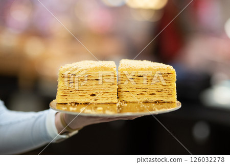 Slice Confectionery Napoleon Cake. Portion of Custard Cream Dessert copy space. Crumbs Around Plate. Bakery Tasty Sweet Dish Closeup 126032278