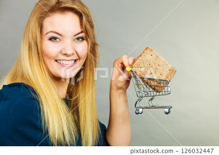 Woman holding shopping cart with bread 126032447