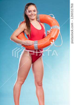 Lifeguard woman on duty with ring buoy lifebuoy. 126032768