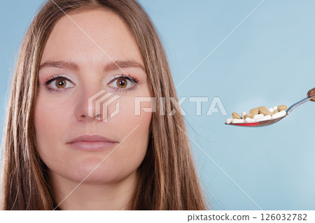 Woman patient taking pills tablets. Drug addict. 126032782