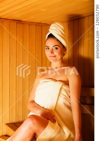 woman relaxing in wooden sauna room woman relaxing in wooden sauna room 126032790