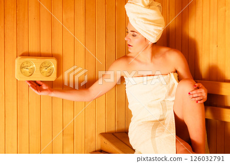 woman relaxing in wooden sauna room woman relaxing in wooden sauna room 126032791