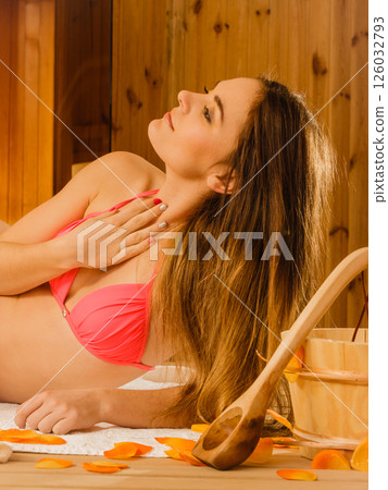 Young woman relaxing in sauna. Spa wellbeing. Young woman relaxing in sauna. Spa wellbeing. 126032793
