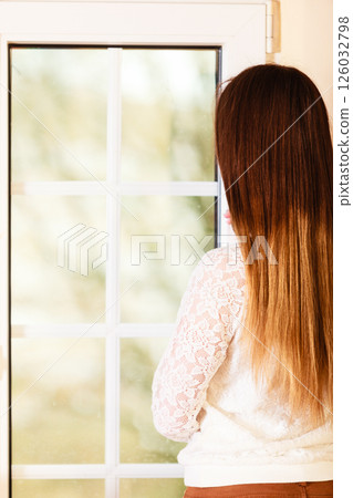 Beautiful woman looking through window. Beautiful woman looking through window. 126032798