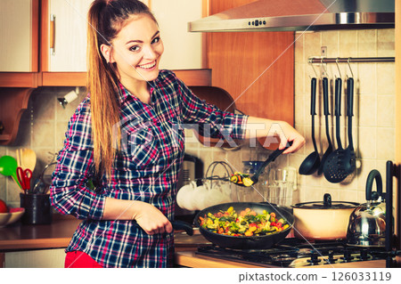 Woman frying frozen vegetables. Stir fry. Woman frying frozen vegetables. Stir fry. 126033119