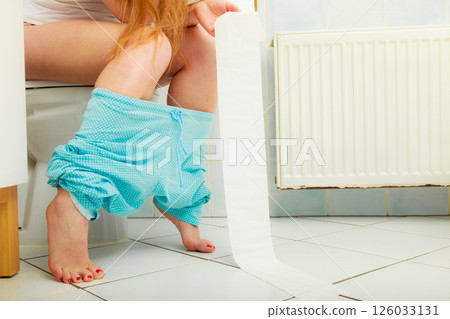 woman sitting on toilet in morning 126033131